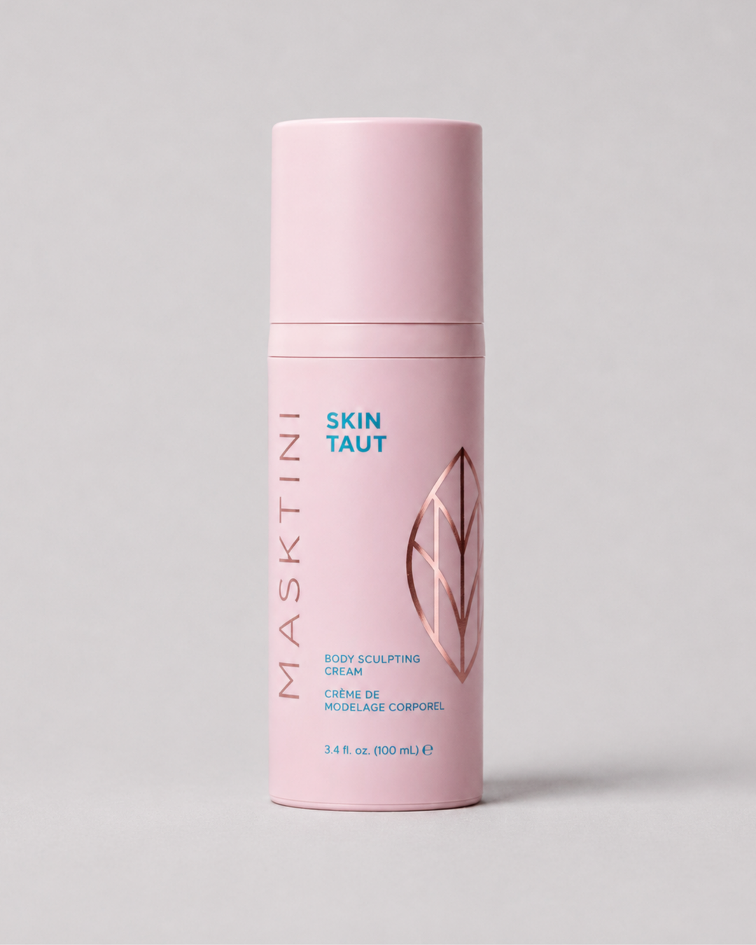 A pink cylindrical bottle of Masktini Skin Taut Body Sculpting Cream, featuring a matching pink cap, with blue and rose gold text and graphics on a neutral gray background.