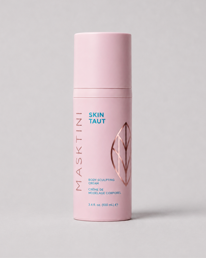 A pink cylindrical bottle of Masktini Skin Taut Body Sculpting Cream, featuring a matching pink cap, with blue and rose gold text and graphics on a neutral gray background.